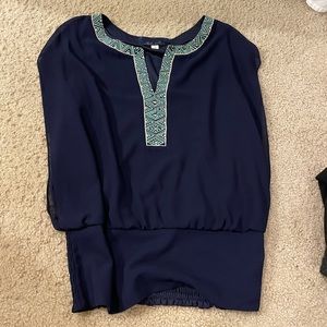 Navy blouse with green beaded detail around collar